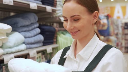 Woman Shops, Touching Soft Towel in Store
