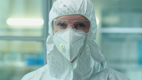 Scientist in Protective Suit Looking at Camera