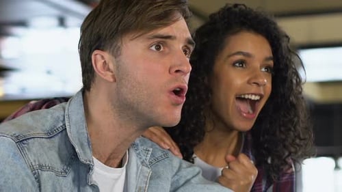 Multiracial Couple Cheering for Favorite Team Victory, Watching Match in Bar