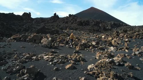 Woman Traveler Walks Through the Lava Field Around Chinyero Volcano in the Teide National Park on
