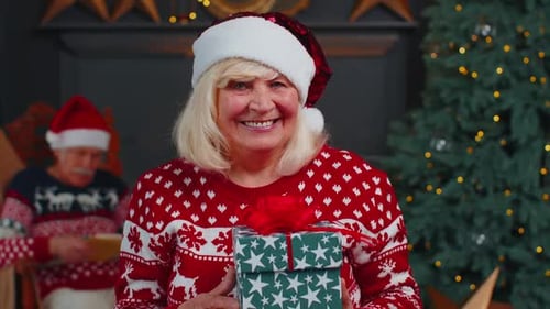Senior Woman Excited Holding Christmas Present
