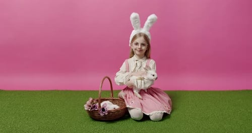 Happy Girl Holding a Bunny in Studio Setting
