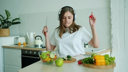 Woman Dancing While Preparing Fresh Salad