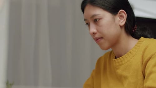 Young caucasian female working on a laptop in her home office during pandemic quarantine.