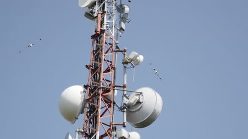 Dish and panel telecommunication equipment on antenna system 4K 3840X2160 UHD tilting footage - Re