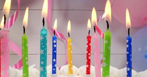 Colorful Birthday Cake with Burning Candles for Celebration