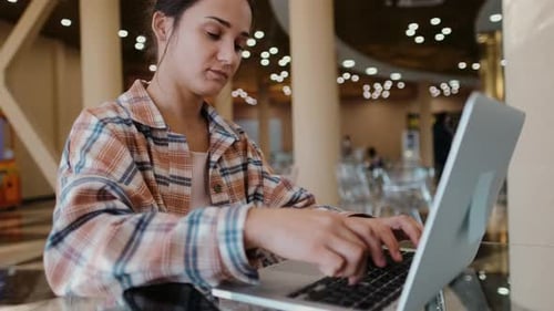 Woman Working with Laptop at the Work Desk. Freelance Blogger Girl Working in Cafe