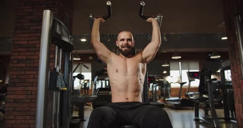 Male Bodybuilder Training His Chest Muscles Working Out with Body Weight Machine