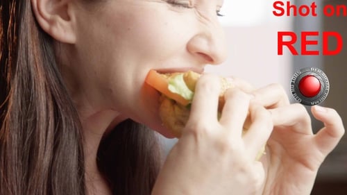 Hungry Woman Eating Burger Enjoying The Taste A Close Up Shot On Red Camera