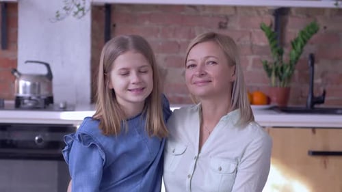 Loving Mother and Daughter Posing in Kitchen