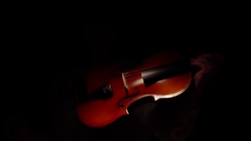 Violinist Playing Violin in Dramatic Dark Lighting