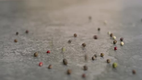 Colorful Mixed Peppercorns Falling on Grey Surface
