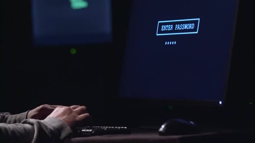 Hands Typing Password on Computer at Night