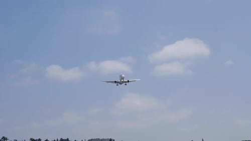 Passenger Plane Approaching for Landing in City