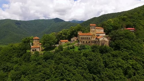 Drone flying away from old Nekresi monastery, view of Alazani valley in Georgia