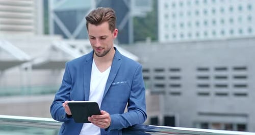 Man Using Tablet in Urban Setting