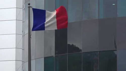 Realistic French Flag Waving in Front of Modern Building