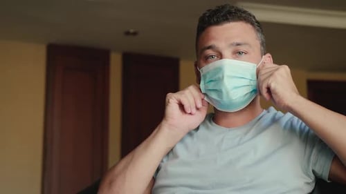 Man Putting on a Medical Mask