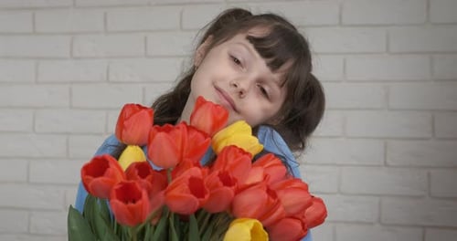 Girl Poses With Bouquet of Colorful Tulips