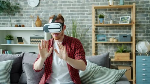 Man Using Virtual Reality Headset on Couch