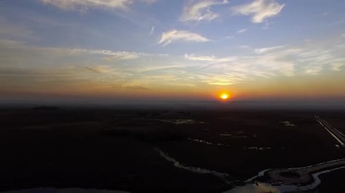 The setting sun hangs just above the horizon, Ibera Wetlands, Corrientes Province, Argentina