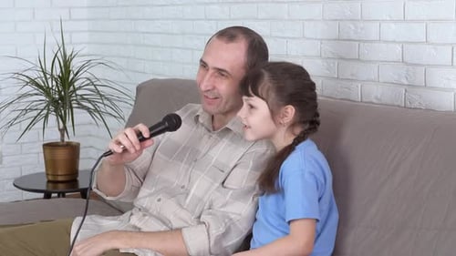 Father and Daughter Singing Together at Home