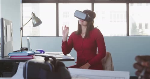 Businesswoman using VR headset in modern office