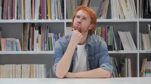 Pensive Man Thinking and Working on Laptop