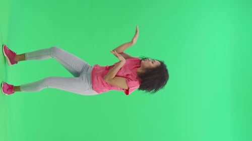 Woman Interacts Against a Green Screen Backdrop