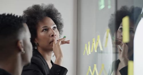 Coworkers Collaborate on Ideas in Modern Office