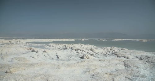 Tracking shot of salt deposits on the banks of the Dead Sea in israel