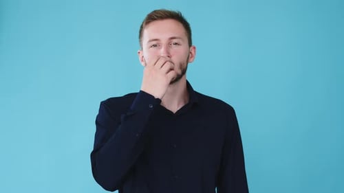 Man Blowing a Kiss on Bright Blue Background