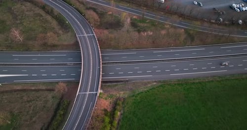 Aerial View of Highway Road Intersection with Fast Moving Heavy Traffic