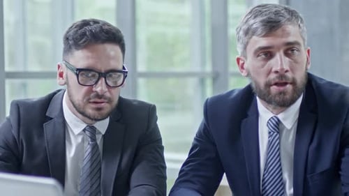 Men Discussing Business at an Office Meeting