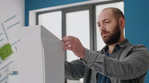 Close Up of Man Engineer Designing Building Model and Maquette Layout for Architecture Work