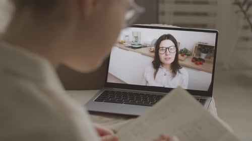 Child Learning Online with Laptop and Teacher