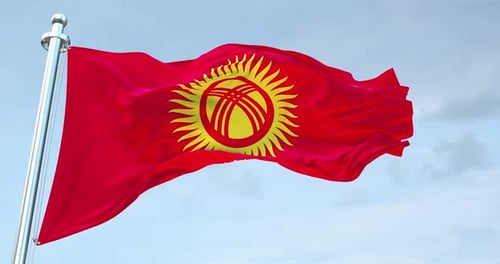 Kyrgyzstan National Flag Waving Against Blue Sky Background