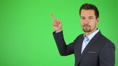 A Young Businessman Talks To the Camera, Pointing at Bullet-point Texts Sliding Toward Him
