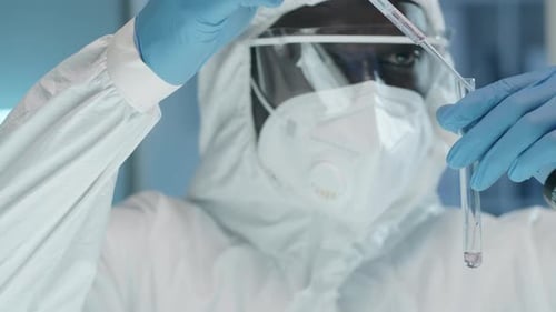 Medical Researcher Adding Liquid to Test Tube