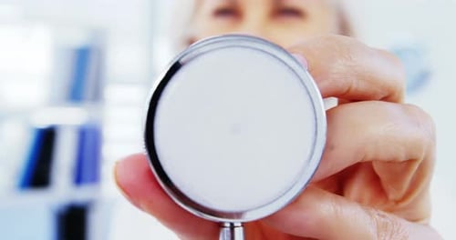 Close-up of female doctor holding stethoscope