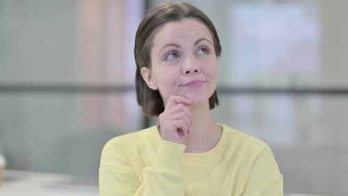 Young Woman Thinking Hard with Hand on Chin