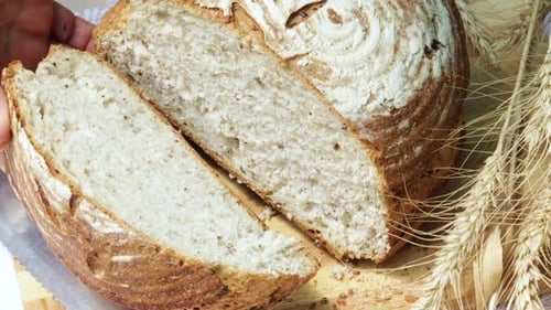Sliced Bread with Wheat Stalks on Cutting Board