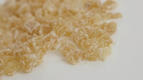 Cooked and candied ginger root on the table close-up slow pan 4K 2160p 30fps UltraHD footage - Crys