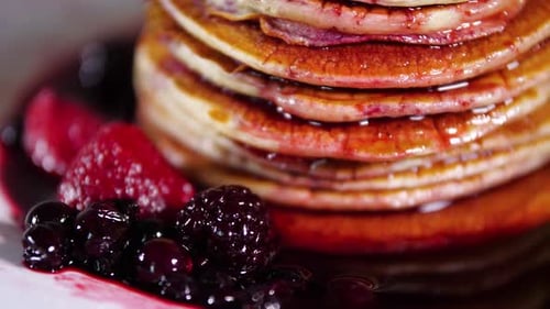 Stack of Pancakes with Berries and Sauce