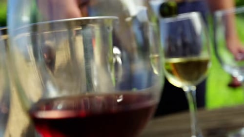 Close-up of man pouring wine in glass