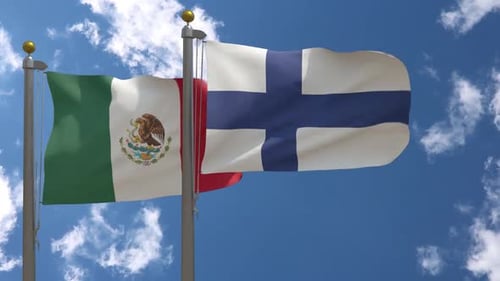 Mexico and Finland Flags Waving Against Blue Sky