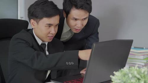 two business man using laptop and discussing project