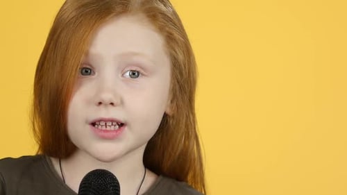 Close-up Child Sings with Microphone and Dance. Slow Motion