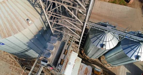Commercial Grain Or Seed Silos In Sunny Spring Rural Landscape