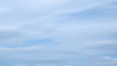 Fluffy Clouds Floating in Blue Sky
